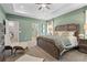 Comfortable main bedroom with a decorative tray ceiling, a ceiling fan, and neutral-toned walls at 106 Asher Dr, Carrollton, GA 30116