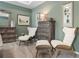 This main bedroom features a sitting area, neutral-toned walls, and lots of dresser storage at 106 Asher Dr, Carrollton, GA 30116