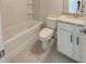 Clean bathroom with white cabinets, granite countertops, and a white bathtub with tiled floors offers modern comfort at 3292 Mill Forest Sw Dr, Conyers, GA 30094