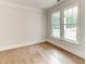 Cozy bedroom with hardwood floors and bright windows offering a serene view at 3292 Mill Forest Sw Dr, Conyers, GA 30094