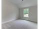 Cozy bedroom featuring soft carpeting, a large window, and recessed lighting at 3292 Mill Forest Sw Dr, Conyers, GA 30094