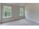 Well-lit bedroom features two large windows, providing ample natural light and outdoor views at 3292 Mill Forest Sw Dr, Conyers, GA 30094