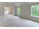 Bright bedroom with two windows offering views of the outdoors, enhanced by neutral carpet at 3292 Mill Forest Sw Dr, Conyers, GA 30094