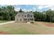 Beautifully landscaped home with a charming front porch and well-manicured lawn at 3292 Mill Forest Sw Dr, Conyers, GA 30094