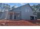 Rear view of new home construction with a covered patio, spacious backyard, and attached garage at 3292 Mill Forest Sw Dr, Conyers, GA 30094