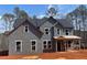 New home under construction featuring a classic two-story design and large windows for ample natural light at 3292 Mill Forest Sw Dr, Conyers, GA 30094