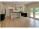 Bright kitchen features an island, stainless steel appliances, and access to the outdoor deck at 3292 Mill Forest Sw Dr, Conyers, GA 30094