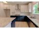A view of the open kitchen with an island, white cabinetry and stainless steel appliances at 3292 Mill Forest Sw Dr, Conyers, GA 30094