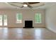 Spacious living room with hardwood floors, fireplace, and ample natural light from French doors at 3292 Mill Forest Sw Dr, Conyers, GA 30094