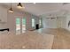 Open concept space featuring a light colored kitchen, island with granite top and living room with modern ceiling fan at 3292 Mill Forest Sw Dr, Conyers, GA 30094