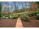 Serene backyard with stone path leading to a cozy fire pit area surrounded by mature trees at 3821 Teesdale Ct, Atlanta, GA 30350