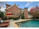 A backyard oasis with a sparkling pool, outdoor dining area, and cozy lounge chairs at 3821 Teesdale Ct, Atlanta, GA 30350