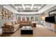 Relaxing basement living area with a large sectional sofa and decorative coffered ceiling at 3821 Teesdale Ct, Atlanta, GA 30350