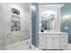 Beautiful bathroom featuring a modern vanity, decorative mirror, and a luxurious marble walk-in shower at 3821 Teesdale Ct, Atlanta, GA 30350