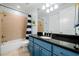 Bright bathroom featuring a black granite countertop, modern fixtures, and a shower-tub combination at 3821 Teesdale Ct, Atlanta, GA 30350