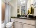 Cozy bathroom with a shower-tub combo and sleek vanity with granite countertop at 3821 Teesdale Ct, Atlanta, GA 30350