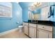 Bright bathroom with a modern vanity, black countertop, and sleek fixtures at 3821 Teesdale Ct, Atlanta, GA 30350