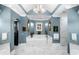 Luxurious bathroom with marble tile, soaking tub, and elegant chandelier at 3821 Teesdale Ct, Atlanta, GA 30350