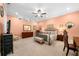 Cozy bedroom with peach walls, carpet flooring, a ceiling fan, and bright natural lighting at 3821 Teesdale Ct, Atlanta, GA 30350