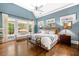 Tranquil main bedroom with blue walls, vaulted ceiling, and large windows at 3821 Teesdale Ct, Atlanta, GA 30350