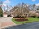 Charming brick two-story home with manicured lawn, mature trees, and welcoming front porch at 3821 Teesdale Ct, Atlanta, GA 30350