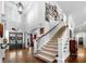 Grand foyer with soaring ceilings, elegant staircase, and beautiful hardwood floors, creating a stunning entrance at 3821 Teesdale Ct, Atlanta, GA 30350