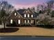 Charming brick home with manicured lawn, featuring a covered porch and dark shutters at 3821 Teesdale Ct, Atlanta, GA 30350