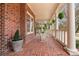 Charming front porch with brick flooring, classic rocking chairs, and elegant column supports at 3821 Teesdale Ct, Atlanta, GA 30350