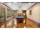 Recreational game room with a pool table, brick fireplace, stained concrete, and built-in shelving at 3821 Teesdale Ct, Atlanta, GA 30350