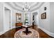 Elegant hallway with decorative rug, chandelier, and classic trim, leading to other rooms in the home at 3821 Teesdale Ct, Atlanta, GA 30350