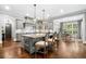 Spacious kitchen with an island, pendant lighting, stainless appliances, and hardwood floors at 3821 Teesdale Ct, Atlanta, GA 30350