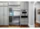 Custom kitchen with a wine fridge, stainless steel microwave and oven, and hardwood floors at 3821 Teesdale Ct, Atlanta, GA 30350