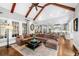 Open living room with a large sectional couch, hardwood floors, and an open kitchen at 3821 Teesdale Ct, Atlanta, GA 30350