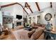 Bright living room with a fireplace, exposed beams, and hardwood floors at 3821 Teesdale Ct, Atlanta, GA 30350