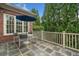 Outdoor patio with stone floors, a blue umbrella, and green trees at 3821 Teesdale Ct, Atlanta, GA 30350