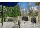 Outdoor patio with stone floors, a grill, and green trees at 3821 Teesdale Ct, Atlanta, GA 30350