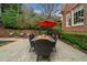 Charming patio with outdoor dining, lounge chairs, umbrella, and tranquil pool views at 3821 Teesdale Ct, Atlanta, GA 30350