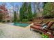 Inviting pool with stone border, manicured landscaping, and comfortable lounge chairs at 3821 Teesdale Ct, Atlanta, GA 30350