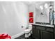 Charming powder room featuring dark vanity, updated fixtures, and stylish tile flooring at 3821 Teesdale Ct, Atlanta, GA 30350
