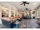 Bright sunroom with brick walls, slate floors, ceiling fans and comfortable seating at 3821 Teesdale Ct, Atlanta, GA 30350