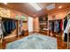 Spacious walk-in closet featuring custom shelving, ample storage, and a stylish blue area rug at 3821 Teesdale Ct, Atlanta, GA 30350