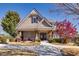 Charming house with a covered front porch, stone accents, well-manicured lawn, and beautiful landscaping at 5888 Cobblestone Creek Cir, Mableton, GA 30126