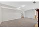 Spacious basement with plush carpeting, neutral walls, and doorway with bathroom access at 713 Shore Ln, Lithonia, GA 30058