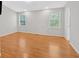 Spacious bedroom featuring hardwood floors, neutral paint, and large windows at 713 Shore Ln, Lithonia, GA 30058