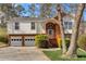 Charming two-story home with brick and white siding, complemented by a well-maintained front lawn at 713 Shore Ln, Lithonia, GA 30058