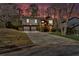 Two-story home with a large driveway, two-car garage, and a neatly landscaped front yard set against a colorful sunset at 713 Shore Ln, Lithonia, GA 30058