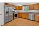Well-lit kitchen features stainless steel appliances, wooden cabinets, and granite countertops at 713 Shore Ln, Lithonia, GA 30058