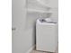 Convenient laundry room with a washer and shelving for storage and organization at 713 Shore Ln, Lithonia, GA 30058