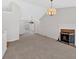 Open-concept living room with vaulted ceiling, fireplace, and sliding glass doors, neutral carpet at 713 Shore Ln, Lithonia, GA 30058