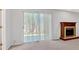 Cozy living room features a fireplace and sliding glass doors leading to the patio at 713 Shore Ln, Lithonia, GA 30058